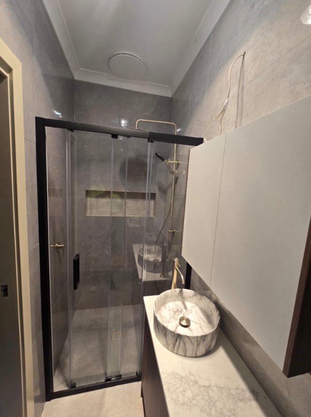 Glass shower screen and vanity photographed during bathroom fitout